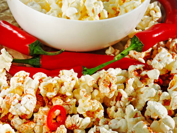 istock Spicy hot popcorn with chili pepper. 1261649862