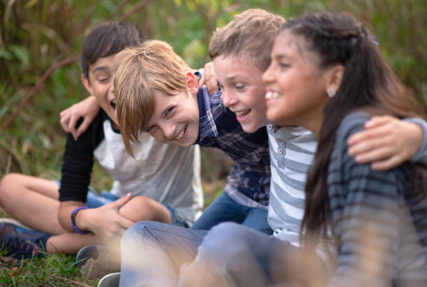 istock Kids laughing together in a natural outdoor setting 1261654671