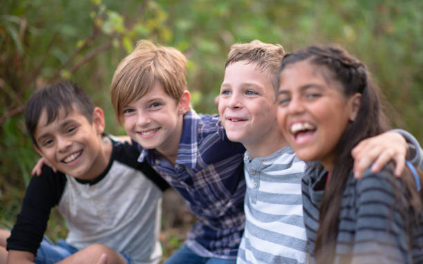 istock Kids laughing together in a natural outdoor setting 1261654782