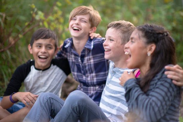 istock Kids laughing together in a natural outdoor setting 1261654784