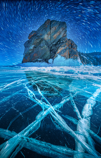 Mountain with star rail in frozen water at Lake Baikal, Siberia, Russia.