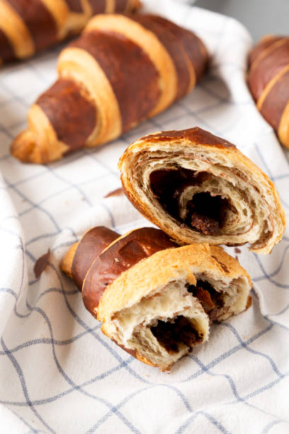 istock Homemade Croissants with Chocolate on cloth, low angle view. Close-up. 1261678257