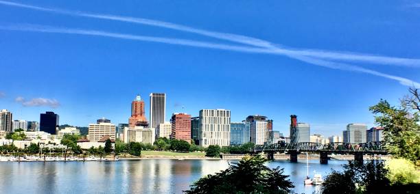 istock downtown portland cityscape reflected - panoramic 1261679089