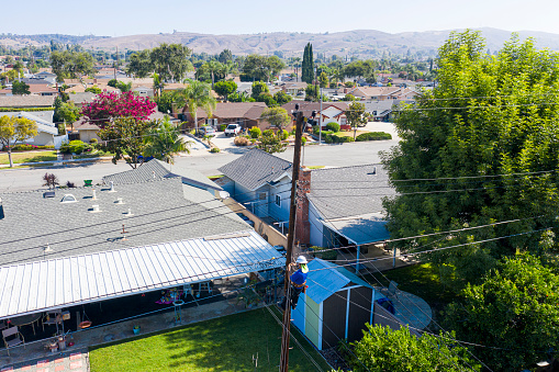 A technician working on the lines in a residential neighborhood