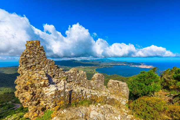 Ruin of the external walls around Volterraio Castle, oldest fortification on Elba Island, Tuscany, Italy, overlooking the gulf of Portoferraio. Panoramic views of Elba and Portoferraio city.
