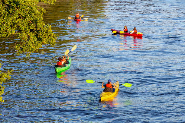 St. Petersburg, Russia - July 27,  2020: Group of kayakers on the river in the sunlight