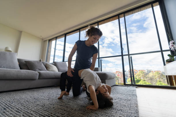 istock Mother teaching her son how to make a gymnastics bridge at home 1261688255