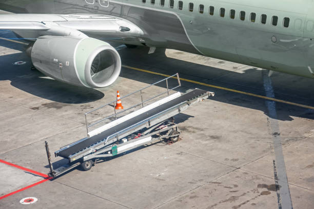 istock Truck for luggage on an airplane, function to loading unloading passenger's luggages near plane. 1261701492