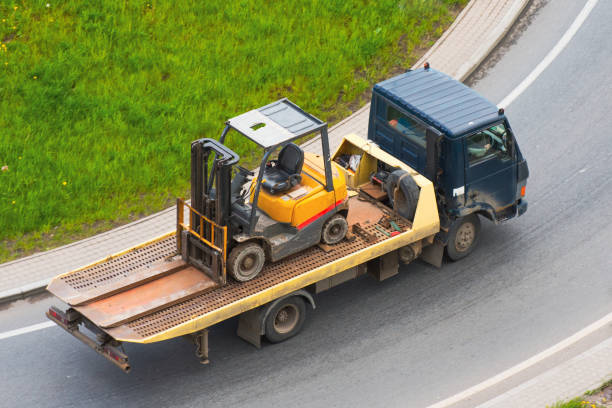 ein lastwagen transportiert denkperstapler auf der straße. - towing tow truck truck semi truck stock-fotos und bilder