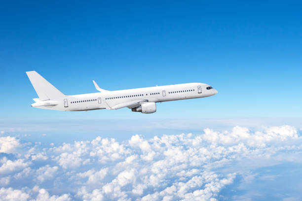istock Passenger plane flight high in the sky above cumulus clouds. 1261709185