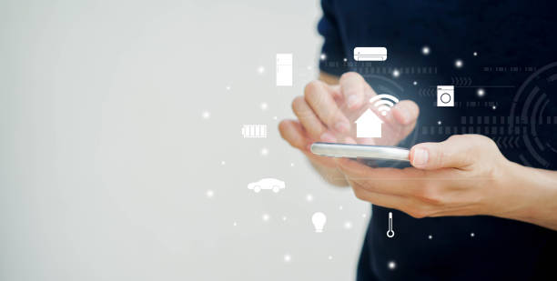 istock close up man holding smartphone and turn on wifi technology and using home automation function at home for looking and monitor inside or outside home and property , ai innovation future concept 1261716805