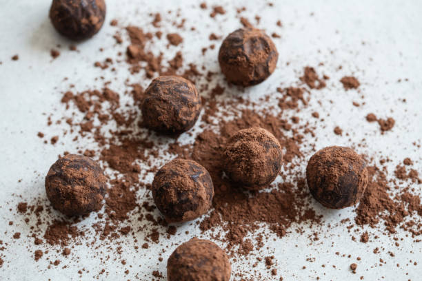 istock Chocolate candy truffle with cocoa powder on a grey background 1261720382