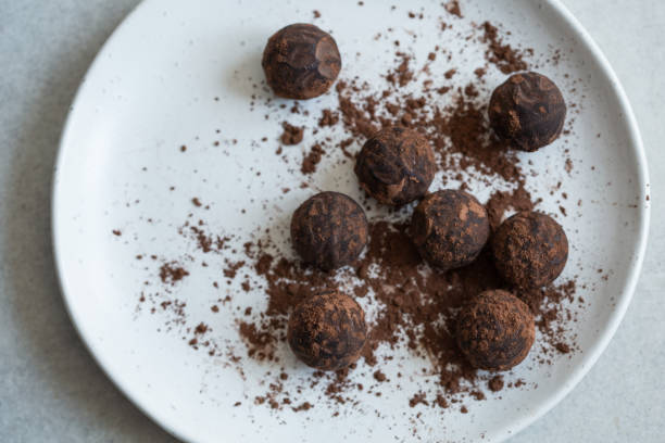 istock Chocolate candy truffle with cocoa powder on a grey background 1261720386