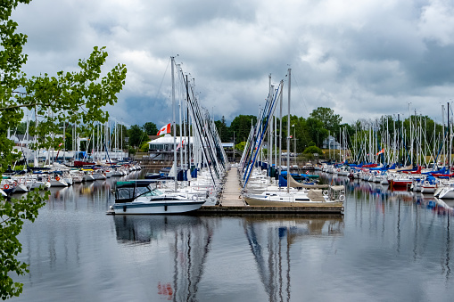 Ottawa, ON, Canada - July 11, 2020: Sailboats are stationed along a dock at the Nepean Sailing Club in Dick Bell Park along the Ottawa River.