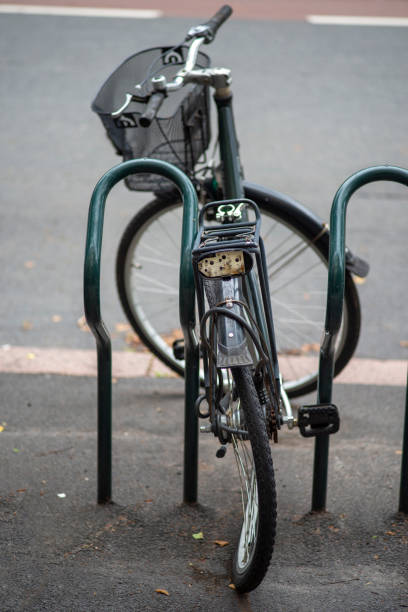 istock Old abandoned bicycle with broken bent wheel locked to a stand. 1261732566