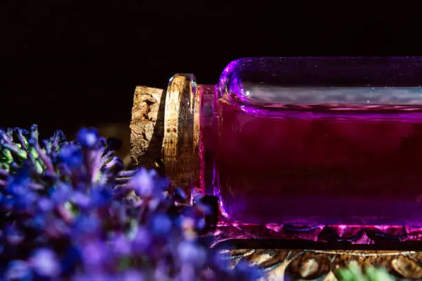 Close-up of a glass stopper bottle containing a pink potion