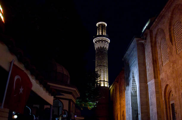 Bodrum, Turkey, 10 13 2024: Minaret of the Merkez Adliye Mosque which is a popular tourist attraction in Bodrum. View from main street in downtown area near the marina and port.