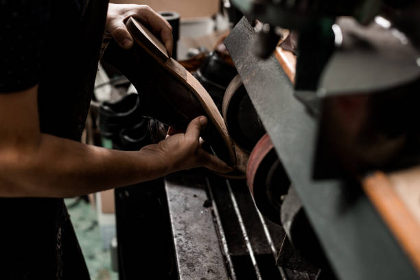 istock Cobbler repairing shoe 1261746088