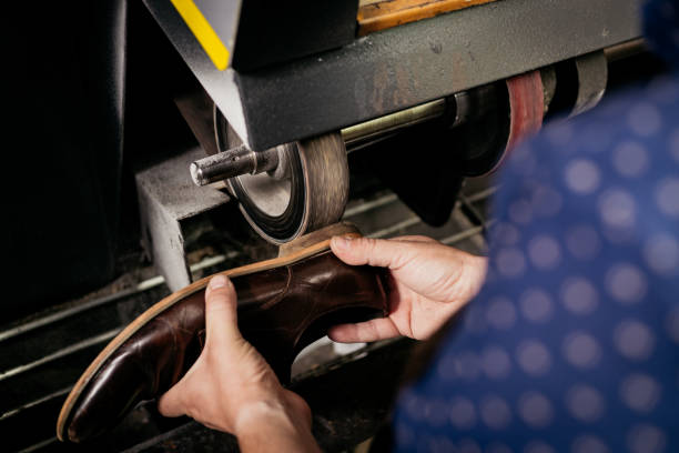 istock Cobbler repairing shoe 1261746613