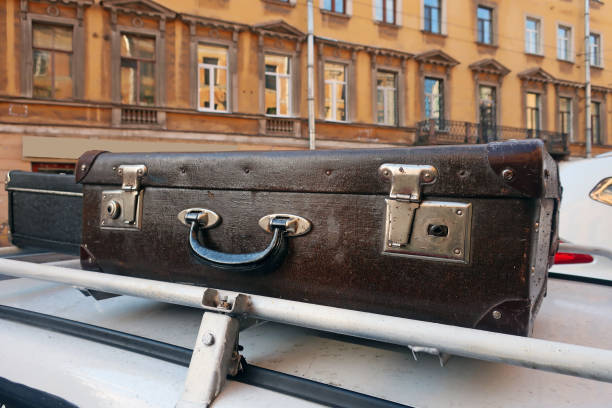 vintage suitcases on the trunk of a car old vintage suitcases on the roof rack of a car going on a trip suitcase luggage old fashioned obsolete stock pictures, royalty-free photos & images