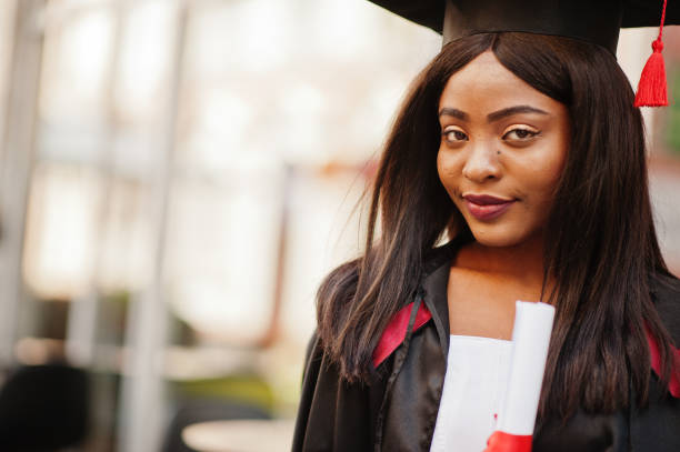 istock Young female african american student with diploma 1261767769