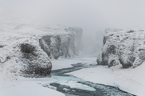 Winter photos snowstorm of Fjadrargljufur canyon in South-Icealand.