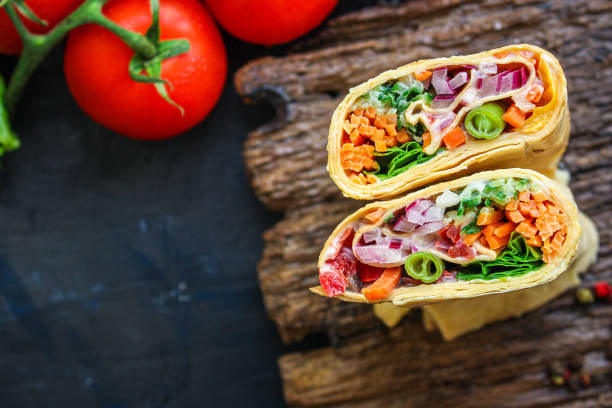 istock tortilla burrito wrap stuffing vegetables lavash vegetarian pita bread Menu concept Takeaway serving size fast food background top view copy space 1261805705