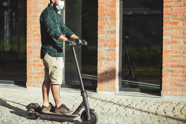 Riding a push scooter in front of a business betrayal stock photo