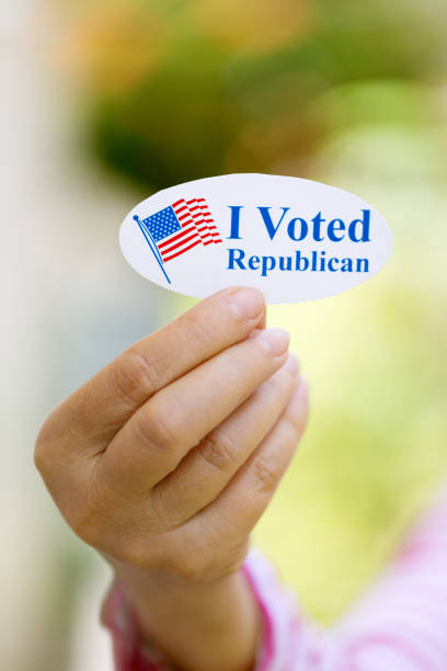 istock Hand holding I voted Republican sticker 1261807344