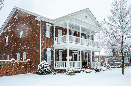 Traditional Brick Home During a Winter Snow Storm
