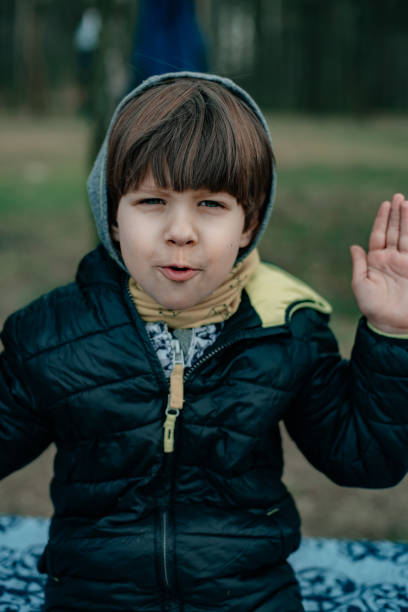 istock A child in nature covered his face with his palms. 1261842864