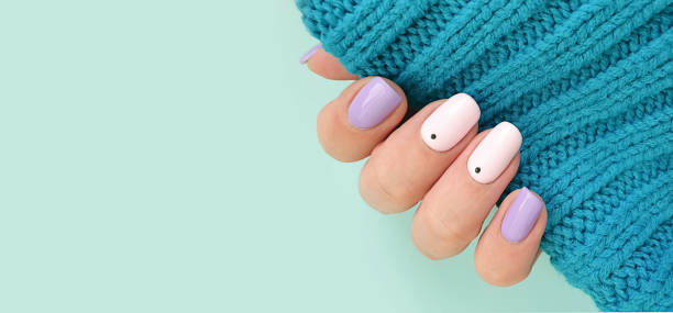 istock female hand beautiful stylish manicure sweater 1261844483