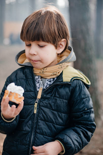 istock A child on a picnic in the forest is eating. 1261844490