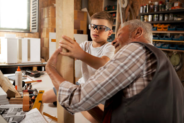 istock Grandfather passing on a skill to a grandson 1261857498