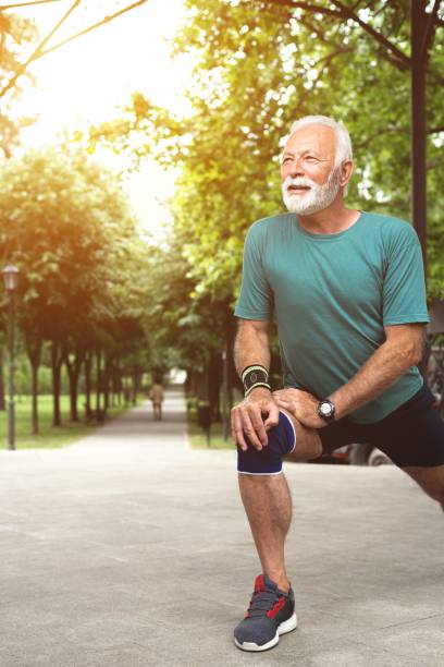 istock Senior man stretching legs before workout at park 1261861498