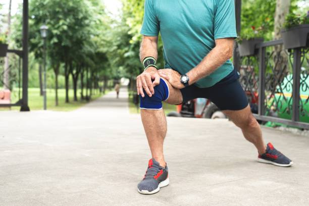 istock Senior man stretching legs before workout at park 1261861503
