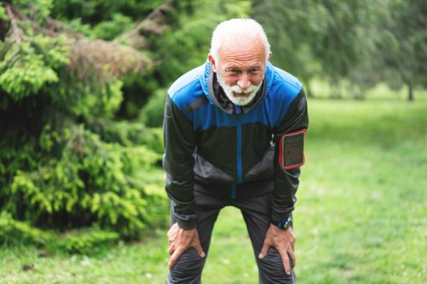 istock Tired man resting after jogging at park 1261862611
