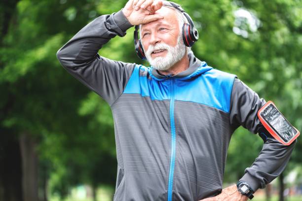 istock Tired man resting after jogging at park 1261862718