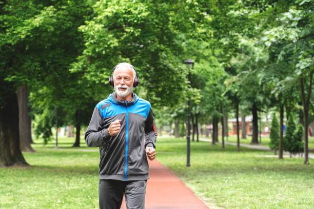 istock Senior man jogging at park 1261863132