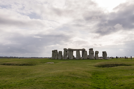 Amesbury, United Kingdom - Mar 18, 2019: Historic Stonehenge late in the day on typical cloudy misty English day as tourist from around the world visit the iconic monument.