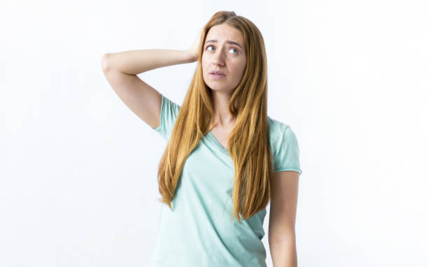 istock Girl looking up in surprise on a white background 1261869648