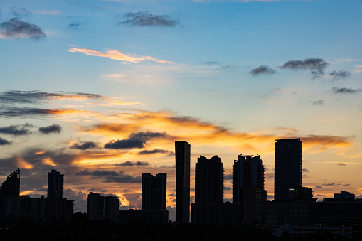 This is a photograph of the Sunny Isles, Florida skyline viewed from a high angle is silhouette at sunset.