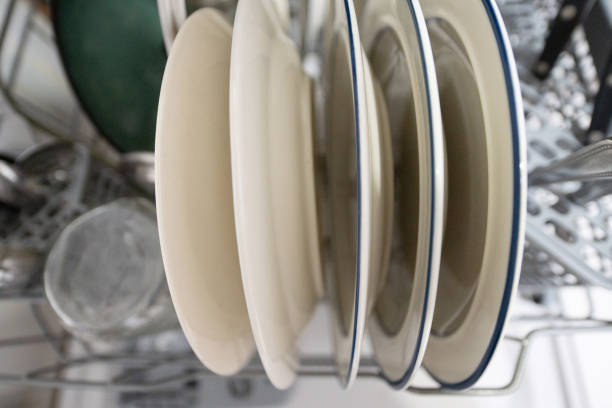 This is a candid photograph of clean dishes in the dishwasher at home.