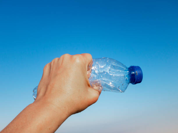 istock Beach plastic bottle is holding in female hand 1261907226