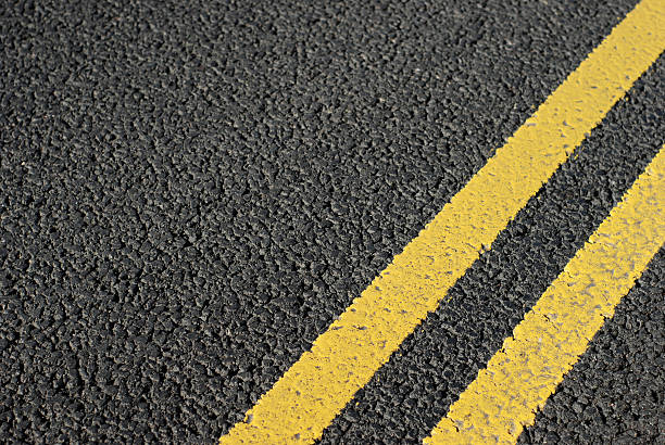 istock Brand new tarmac yellow lines background 126191937
