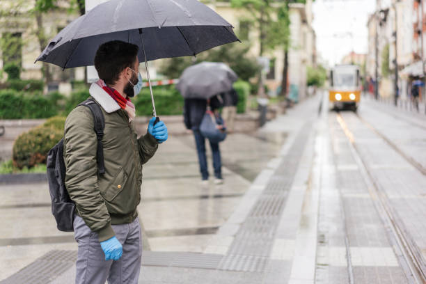 istock Man waiting at the tram station during Covid-19 outbreak 1261920298