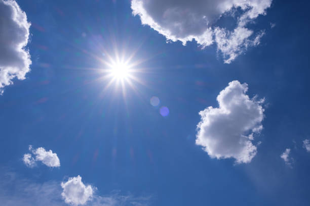 istock Blue sky with white clouds and sun  rays. Summer spring heaven concept. Background for textures backgrounds and web banners design 1261941860
