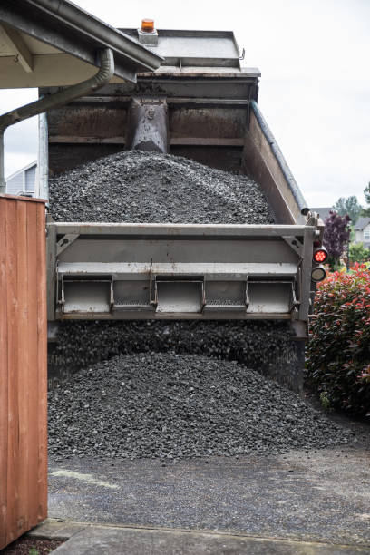 istock Dump Truck Unloading Crushed Rock at Home Driveway for Gravel Delivery 1261989503