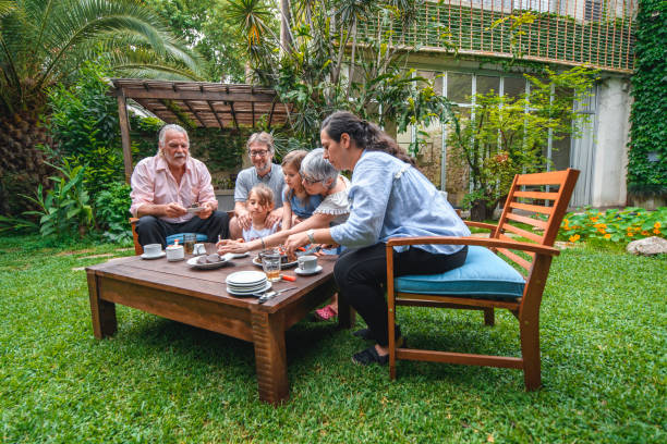 istock Cutting Birthday Cake in Backyard for Family Celebration 1262024709
