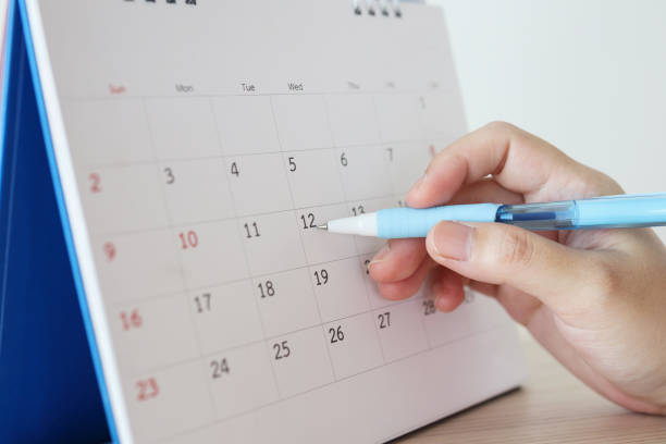 istock Hand with pen writing on calendar date 1262025892